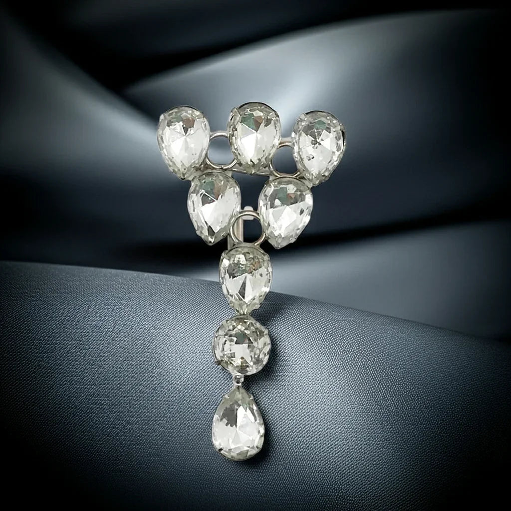 This vintage brooch, purchased in 1984 in New York, features large pear-shaped faceted stones and is set in silver tone metal. Shine bright like a diamond (or, like a faceted stone) with this stunning vintage brooch