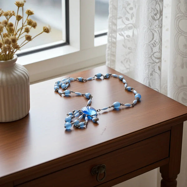 Antique Czechoslovakian Sky Blue Art Glass Drop Negligee Necklace, this gorgeous necklace was crafted to showcase the unique beauty of antique Czechoslovakian artistry. It boasts pale blue art glass beads accented by four graduated drops. 