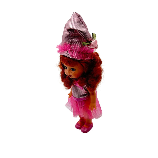 Kelly appears as Lullaby Munchkin doll from The Wizard of Oz collection. This charming figure dressed as the iconic Lullaby Munchkin character.