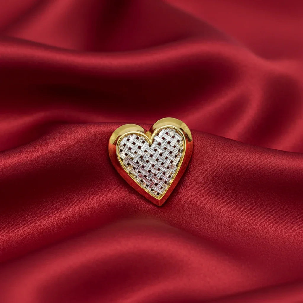 This is a bold and striking brooch by famed designer Nolan Miller. His pieces are consistently high quality and this heart shaped brooch is an excellent example of that, with it's smooth gold tone border and its perfectly set, clear and bright baguettes forming a woven-look appearance. 