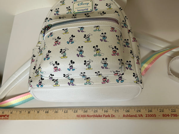  Enjoy the exclusive, pastel rainbow charm of our Loungefly Disney Pastel Rainbow Mickey Mouse Mini Backpack. Adjustable straps add comfort. Very hard to find