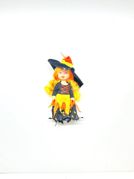 Vintage Mattel Barbie Kelly Club Halloween Party "Kelly is a Witch" doll. Loose mini doll wearing a candy corn themed witch costume with a black hat, standing against a white backdrop