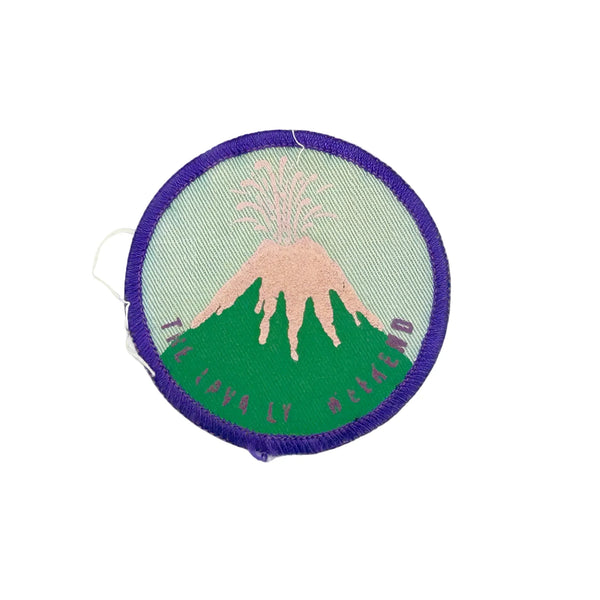 Commemorate a pivotal moment in natural history with this authentic Girl Scout Mount St. Helens patch from the early 1980s. Created in the wake of the volcano's catastrophic 1980 eruption, this Junior Girl Scout badge captures the dramatic geological event through embroidery—a volcano erupting in shades of pink against a serene blue-green sky.