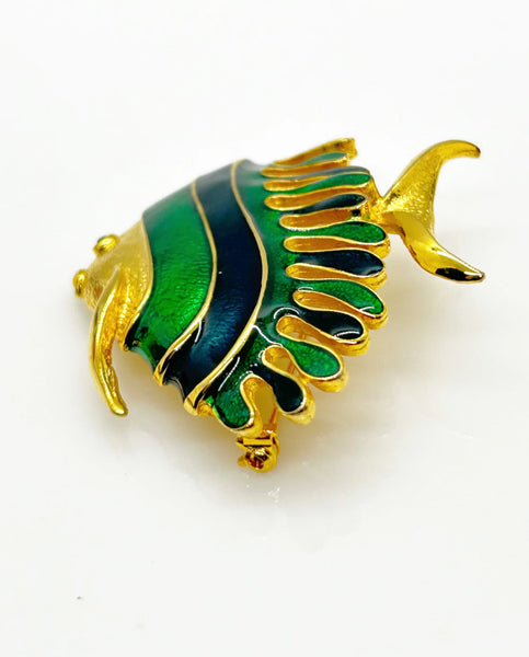 This charming angel fish brooch is a work of art with its vibrant blue and green enamel on a golden backdrop. His vibrant green eye will see all of the compliments you'll receive.