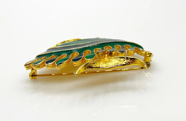 This charming angel fish brooch is a work of art with its vibrant blue and green enamel on a golden backdrop. His vibrant green eye will see all of the compliments you'll receive.