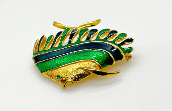This charming angel fish brooch is a work of art with its vibrant blue and green enamel on a golden backdrop. His vibrant green eye will see all of the compliments you'll receive.