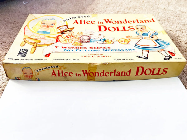 This is a vintage boxed set of "Animated Alice in Wonderland Dolls" paper dolls manufactured by the Milton Bradley Company. The set, number 4109, was designed by Emma C. McKean and includes seven scene cards where the dolls can be inserted into die-cut slits to "animate" the scenes.