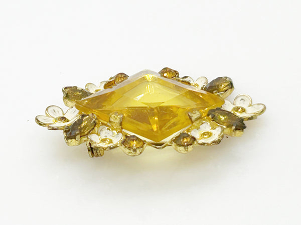 Perfect for vintage jewelry lovers: our Antique Clear Yellow Stone Floral Czech Brooch provides timeless elegance with enameled flowers and a clear center stone. Shop today!