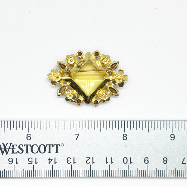 Perfect for vintage jewelry lovers: our Antique Clear Yellow Stone Floral Czech Brooch provides timeless elegance with enameled flowers and a clear center stone. Shop today!