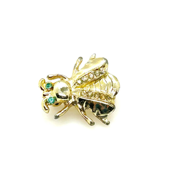 Bring a touch of springtime charm to your ensemble with this exquisite vintage bumble bee brooch. ;Featuring captivating bright aqua green eyes and wings adorned with sparkling, tiny rhinestones, this 1" piece is the ideal accent to add a radiant and nature-inspired flair to any outfit