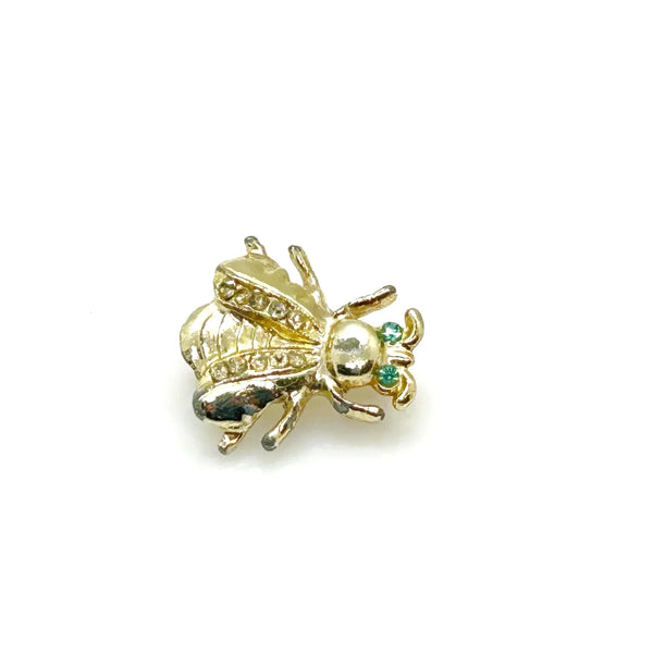 Bring a touch of springtime charm to your ensemble with this exquisite vintage bumble bee brooch. ;Featuring captivating bright aqua green eyes and wings adorned with sparkling, tiny rhinestones, this 1" piece is the ideal accent to add a radiant and nature-inspired flair to any outfit