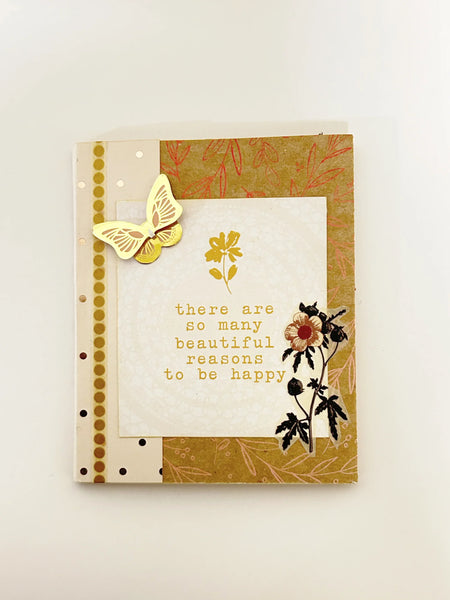 This handmade mixed media "Beautiful Reasons" mini album is a charming, butterfly-themed mini journal crafted with care and creativity. Featuring soothing shades of sand, olive green, and subtle red accents, it invites you to capture your most special memories and inspirations.