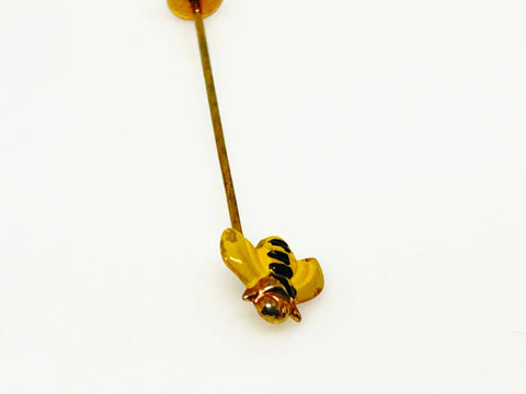 This charming vintage stick pin features a delightful black and gold bee design. The pin measures 1.75” in length, making it a perfect accessory to add a touch of whimsy to any outfit.