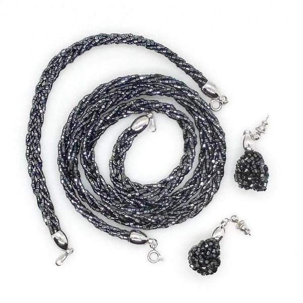 Shop a rare vintage Crown Trifari black braided beaded jewelry set. Features a matching multi-strand glass seed bead torsade necklace, bracelet & dangle earrings.
