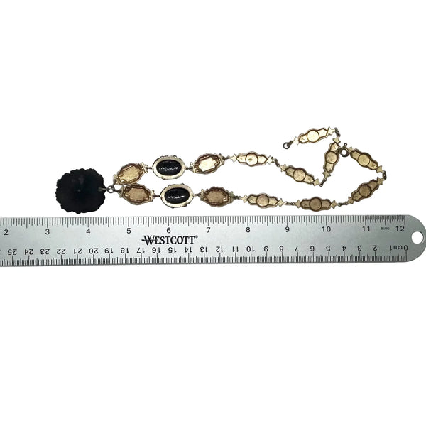 Vintage Art Deco choker necklace featuring gold-tone brass filigree links, two oval black beads, and a large textured black cluster central pendant