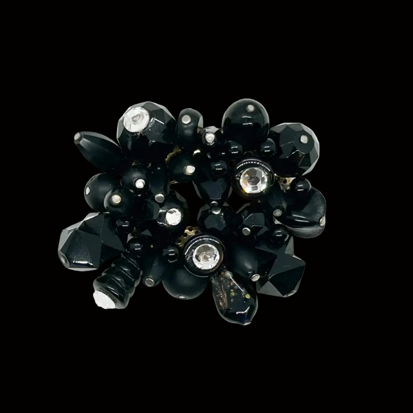 Perfect for vintage lovers: our handcrafted brooch provides a unique blend of black beads and sparkling rhinestones for an eye-catching statement. Shop today!