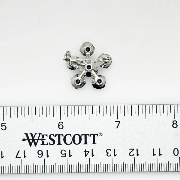Measuring a delicate .75" across, this piece radiates timeless elegance. The unforgettable, eye-catching blue hue is beautifully complemented by the subtle "Coro" script signature discreetly placed on the back of the piece, adding a touch of authenticity and sophistication to this charming vintage treasure.