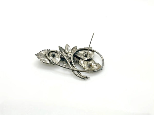 Vintage Silver-Tone Floral Brooch with Blue Rhinestone Center and Textured Leaves