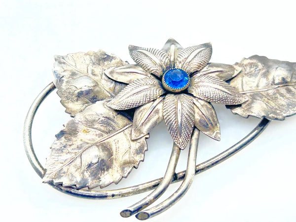 Vintage Silver-Tone Floral Brooch with Blue Rhinestone Center and Textured Leaves