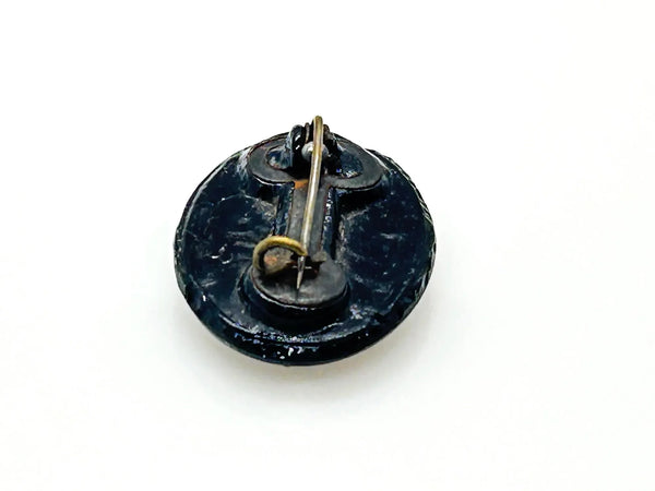 Discover this exquisite antique Victorian black glass brooch, a poignant piece of mourning jewelry originating from the mid-to-late 19th century. This captivating oval brooch boasts a delicately beaded border, framing a mesmerizing central design that evokes either a floral motif or a radiant starburst pattern. 