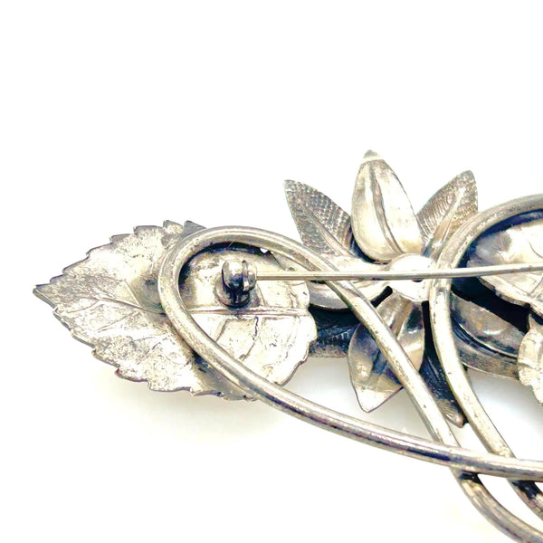 Vintage Silver-Tone Floral Brooch with Blue Rhinestone Center and Textured Leaves