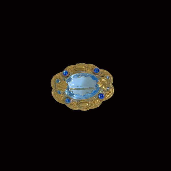 Beautiful Pale Blue Old World Brooch - Features intricate vintage craftsmanship with detailed metal and multiple shimmering blue stones. Shop now!