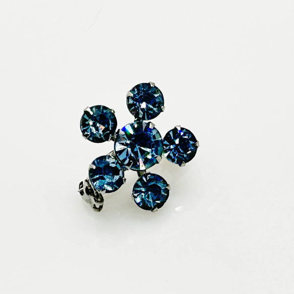 Measuring a delicate .75" across, this piece radiates timeless elegance. The unforgettable, eye-catching blue hue is beautifully complemented by the subtle "Coro" script signature discreetly placed on the back of the piece, adding a touch of authenticity and sophistication to this charming vintage treasure.