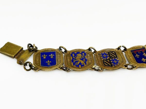 Perfect for vintage jewelry lovers: our Vintage French Souvenir Panel Bracelet provides a stunning display of French heraldic crests. Shop today!