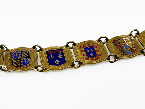 Perfect for vintage jewelry lovers: our Vintage French Souvenir Panel Bracelet provides a stunning display of French heraldic crests. Shop today!