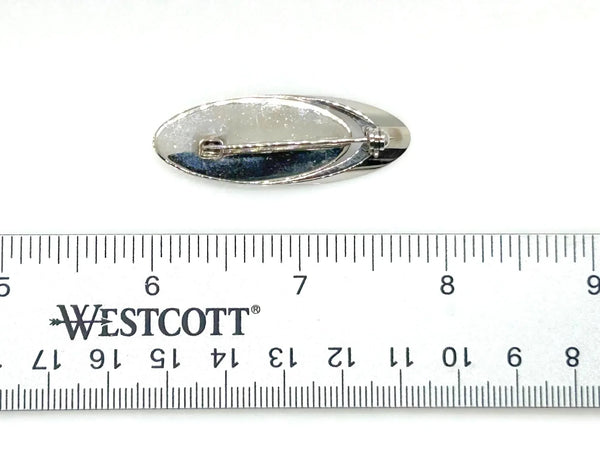 Vintage mid-century modern oval silver brooch featuring an iridescent blue and green Paua abalone shell cabochon.