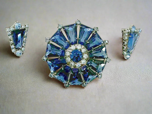 This focal point of this set are the deep blue trapezoid rhinestones set in a round frame. There have accents of lighter blue round stones, with a matching deep blue round stone in the center. The earrings are set with one of the deep blue stones and framed with the paler blue stones.