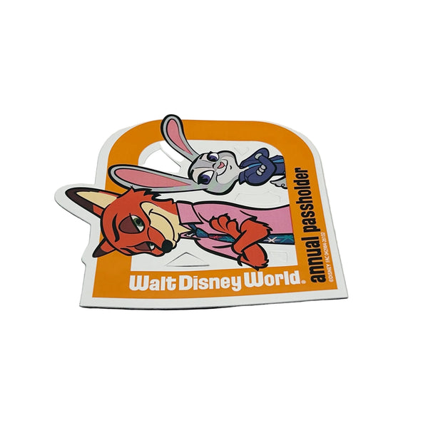 Celebrate your Disney magic with this cheerful 2026 Walt Disney World Annual Passholder Magnet featuring Nick Wilde and Judy Hopps from Zootopia! Shaped like a bold capital 'D', this exclusive winter edition magnet showcases the beloved fox-and-bunny duo in vibrant detail.