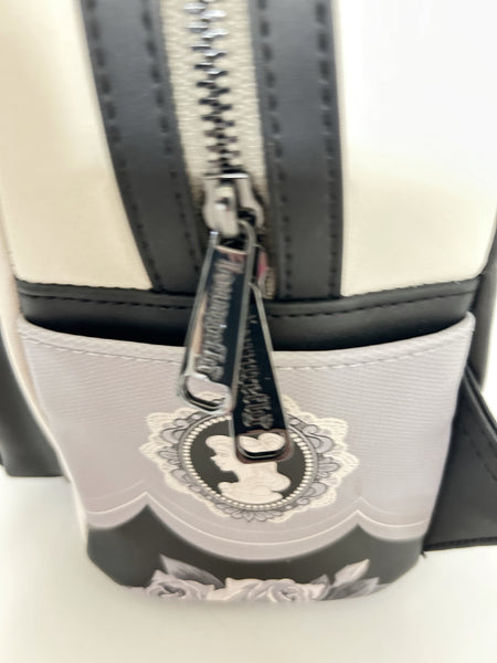 Loungefly Disney Princess Cameo Portraits Mini Backpack—a stunning 2024 release that celebrates timeless elegance! This cream vegan leather beauty showcases exquisite silhouette portraits of your favorite Disney Princesses in sophisticated black and white.