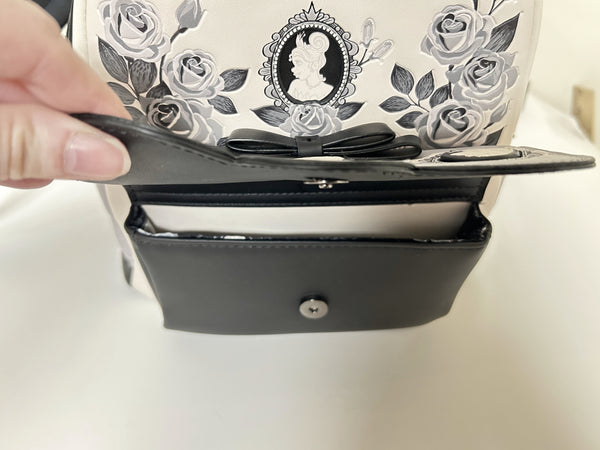 Loungefly Disney Princess Cameo Portraits Mini Backpack—a stunning 2024 release that celebrates timeless elegance! This cream vegan leather beauty showcases exquisite silhouette portraits of your favorite Disney Princesses in sophisticated black and white.