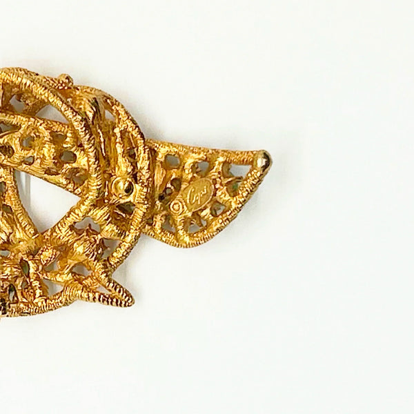 1960s vintage Capri openwork curl brooch featuring textured gold-tone metal set with green faux jade and red carnelian glass cabochons