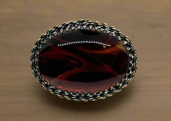 This vintage designer beauty measures 3” across and seems every changing in the light- sometimes it appears to have red, other times clear honey, other times rich brown shades. It’s an excellent example of faux tortoise, and shows the remarkable craftsmanship found in&nbsp;Carnegie pieces