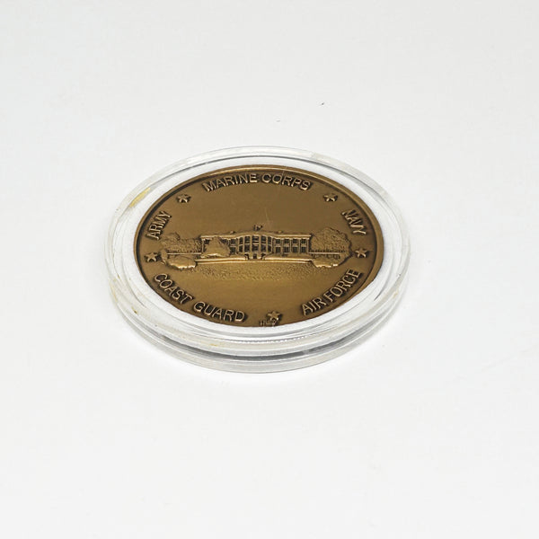 bronze-colored White House Military Office Challenge Coin. It features an image of the White House surrounded by the names of the five military branches: Army, Navy, Air Force, Marine Corps, and Coast Guard.