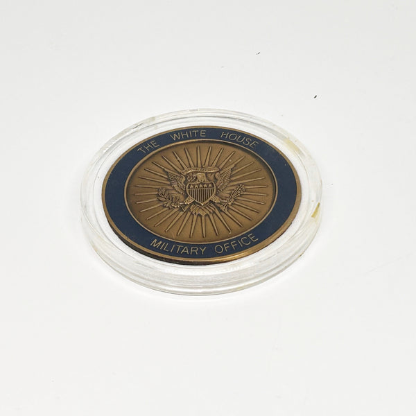 bronze-colored White House Military Office Challenge Coin. It features an image of the White House surrounded by the names of the five military branches: Army, Navy, Air Force, Marine Corps, and Coast Guard.