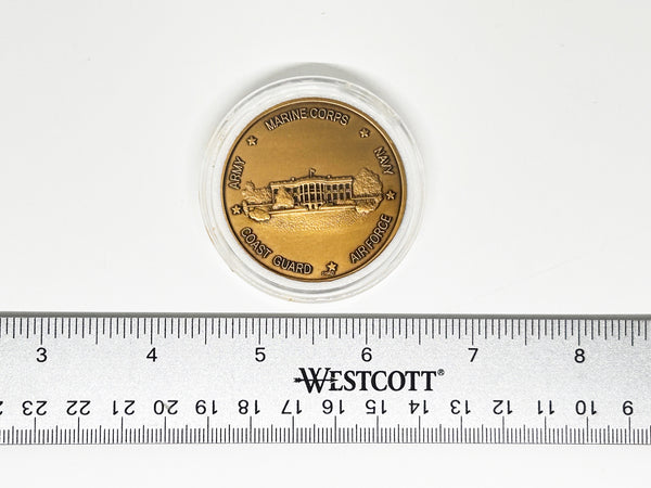 bronze-colored White House Military Office Challenge Coin. It features an image of the White House surrounded by the names of the five military branches: Army, Navy, Air Force, Marine Corps, and Coast Guard.