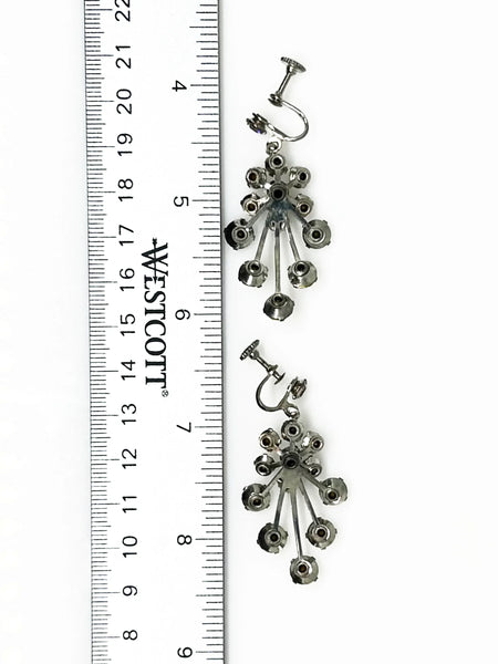 Enhance your elegance with these exquisite vintage drop earrings adorned with varying sizes of round rhinestones, intricately arranged to create a sophisticated design. 