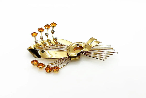This is a massive Coro Sterling Floral Spray &amp; Ribbon Design brooch. Get mesmerized by the splendor of this vintage brooch, measuring just under 4 inches. The bouquet, intricately designed with a bow, boasts of four gold-toned lines adorned with round, citrine-orange stones of varying sizes.