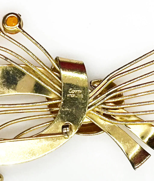 This is a massive Coro Sterling Floral Spray &amp; Ribbon Design brooch. Get mesmerized by the splendor of this vintage brooch, measuring just under 4 inches. The bouquet, intricately designed with a bow, boasts of four gold-toned lines adorned with round, citrine-orange stones of varying sizes.
