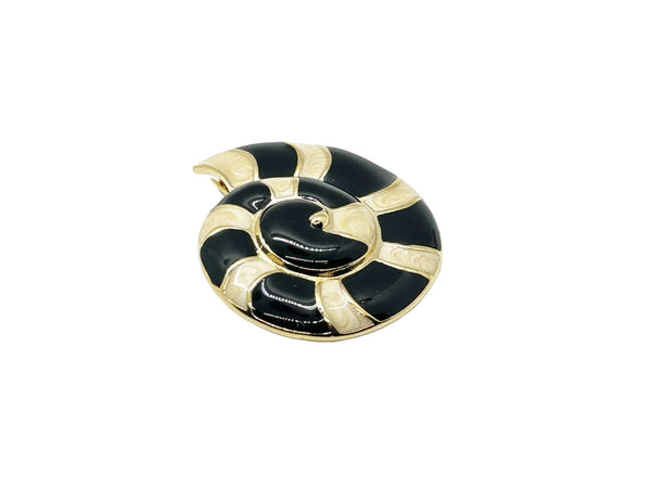 This stunning Trifari brooch captures the elegance of Art Deco design with its spiral seashell silhouette. Crafted in gold-tone metal, it features striking black enamel paired with creamy golden-sand enamel in a sophisticated moire finish.