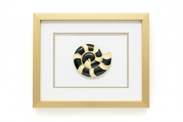This stunning Trifari brooch captures the elegance of Art Deco design with its spiral seashell silhouette. 