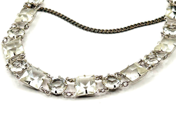Vintage Art Deco style clear rhinestone geometric bracelet with alternating round and square-cut crystal links in a silver-tone setting on a plain white background