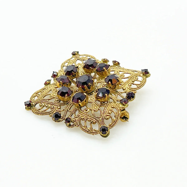Intricate Vintage Gold Tone Brooch with Ruby Red Stones - Add timeless charm with this ornate brooch featuring deep ruby red stones. Perfect statement piece. Shop now!