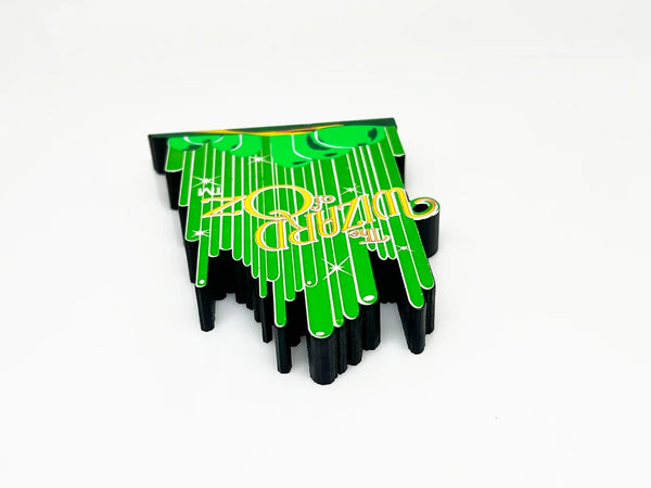 Bring a touch of classic Hollywood magic to your collection with this charming wooden Emerald City shelf sitter from Sheila's Collectibles. Crafted in the 1990s, this iconic piece captures the whimsical green spires of Oz in meticulous detail, complete with "The Wizard of Oz" branding.