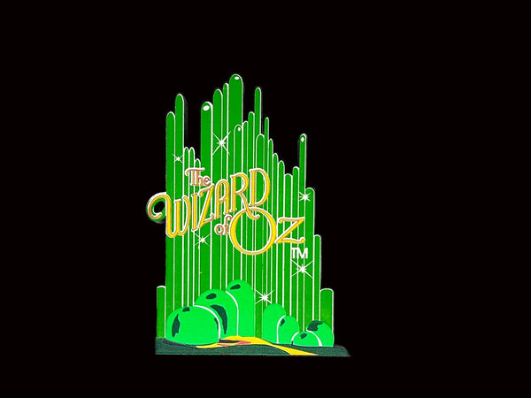 Bring a touch of classic Hollywood magic to your collection with this charming wooden Emerald City shelf sitter from Sheila's Collectibles. Crafted in the 1990s, this iconic piece captures the whimsical green spires of Oz in meticulous detail, complete with "The Wizard of Oz" branding.