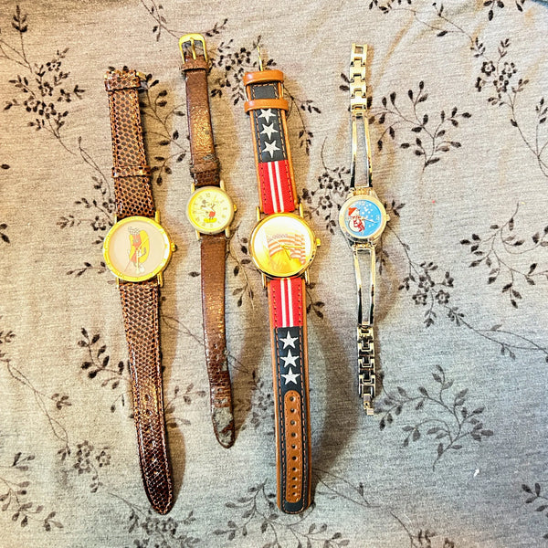 This is a group of four ladies' watches featuring graphic designs - an American flag, Mickey Mouse, a hot dog and a snowman. I don't know if any work, or just require batteries or can be repaired.  The lot would also provide parts for other watches or even craft projects. They are untested.