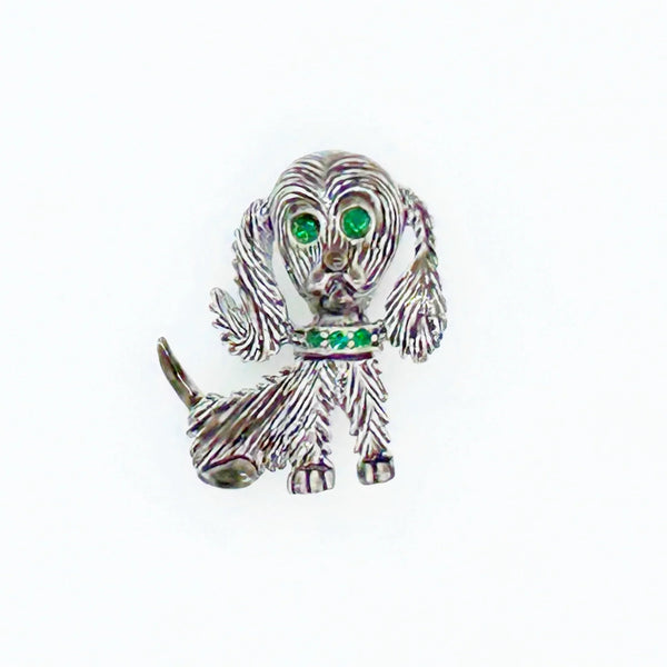 This vintage brooch shows an adorable, floppy eared puppy dog. He has bright green eyes and collar and wagging tail. He's just waiting for you!! His coat is well detailed in silver tone metal. He or she measures 1 3/4" tall and is marked "Gerry's" in capitals on the white enamel back.